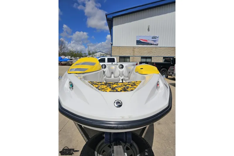 Slide: The Image of 2007 Sea-Doo 150 Speedster boat with yellow accents, parked outdoors under a blue sky. - 15