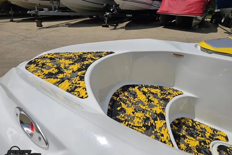 Slide: The Image of 2007 Sea-Doo 150 Speedster boat interior with yellow and black camo design. - 17