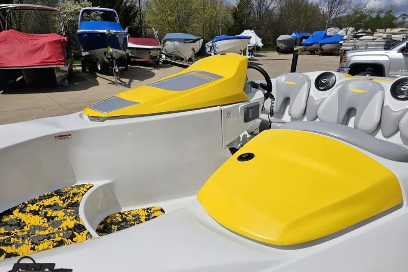 Slide: The Image of 2007 Sea-Doo Sport Boats 150 Speedster with vibrant yellow accents, parked among other boats. - 18