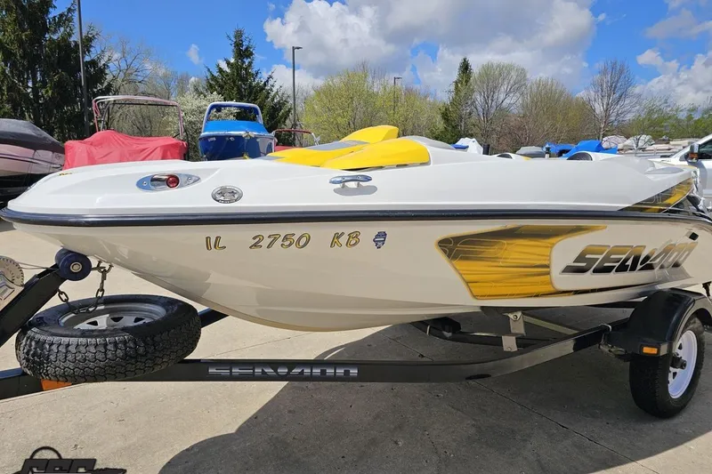 Slide: The Image of 2007 Sea-Doo 150 Speedster boat on trailer, parked outdoors under a blue sky. - 21