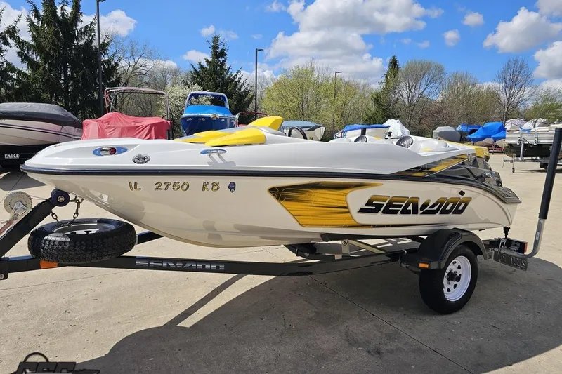Slide: The Image of 2007 Sea-Doo 150 Speedster boat on trailer, parked outdoors under a clear sky. - 22