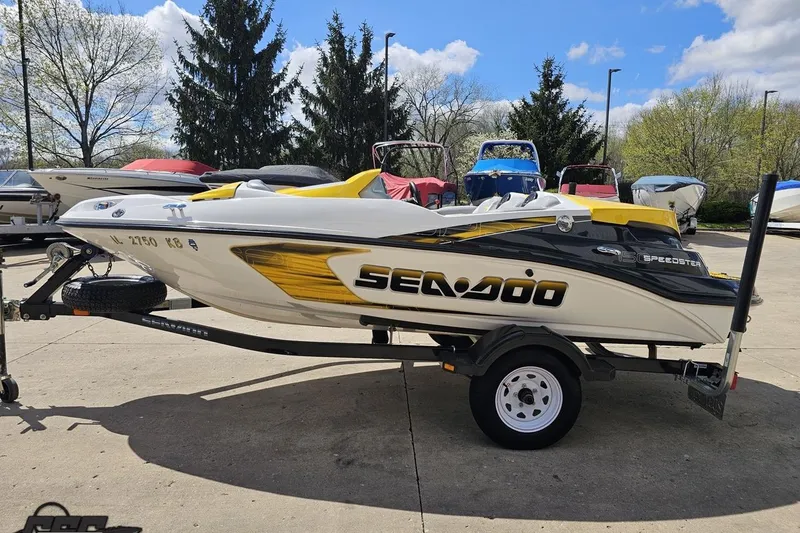 Slide: The Image of 2007 Sea-Doo 150 Speedster boat on trailer, parked outdoors on a sunny day. - 23
