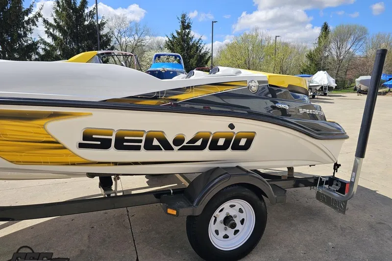 Slide: The Image of 2007 Sea-Doo 150 Speedster boat on trailer, parked outdoors under a blue sky. - 24