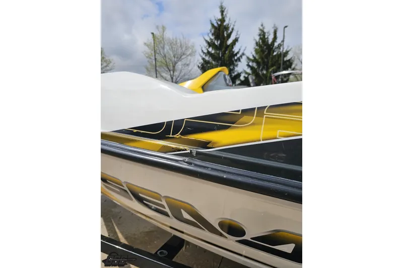 Slide: The Image of 2007 Sea-Doo 150 Speedster boat with yellow and black detailing, parked outdoors. - 26