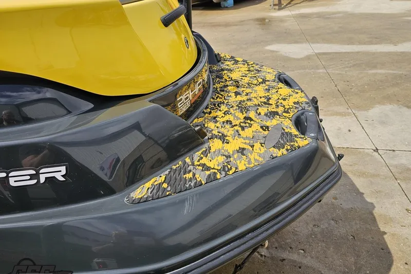 Slide: The Image of 2007 Sea-Doo 150 Speedster with yellow and black detailing on a concrete surface. - 28