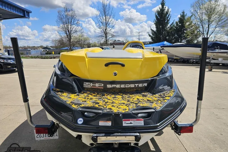 Slide: The Image of 2007 Sea-Doo 150 Speedster boat, yellow and black, parked outdoors on a sunny day. - 30