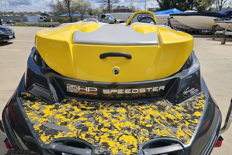 Slide: The Image of 2007 Sea-Doo 150 Speedster boat, yellow and black design, parked outdoors. - 32