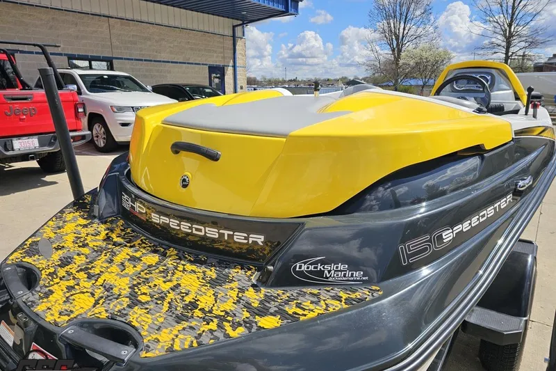 Slide: The Image of 2007 Sea-Doo 150 Speedster boat in yellow and gray, parked outdoors. - 36