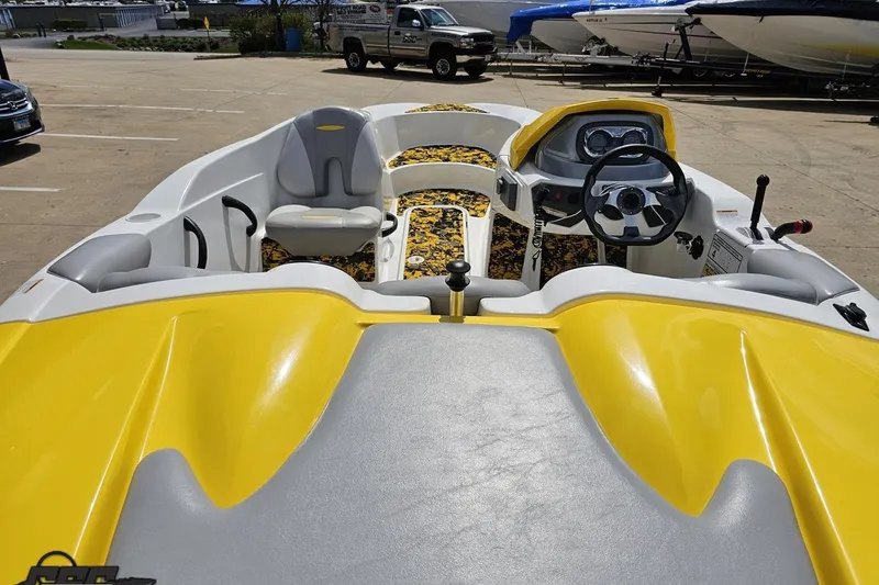 Slide: The Image of 2007 Sea-Doo 150 Speedster boat interior with yellow accents and steering wheel. - 45