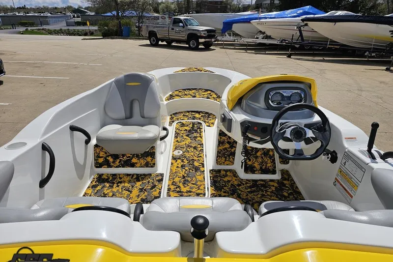 Slide: The Image of 2007 Sea-Doo 150 Speedster boat interior with yellow accents and steering wheel. - 47