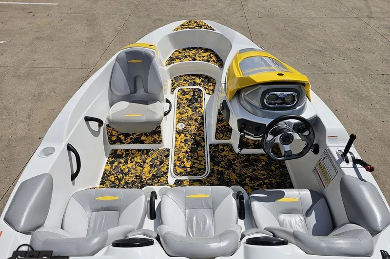 Slide: The Image of 2007 Sea-Doo 150 Speedster boat interior with yellow accents and patterned flooring. - 48