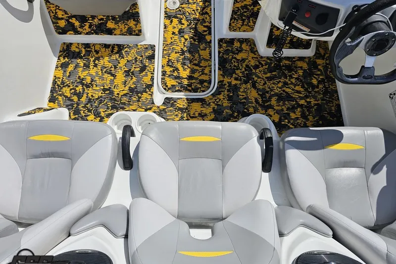 Slide: The Image of 2007 Sea-Doo 150 Speedster interior with gray seats and yellow-accented flooring. - 51