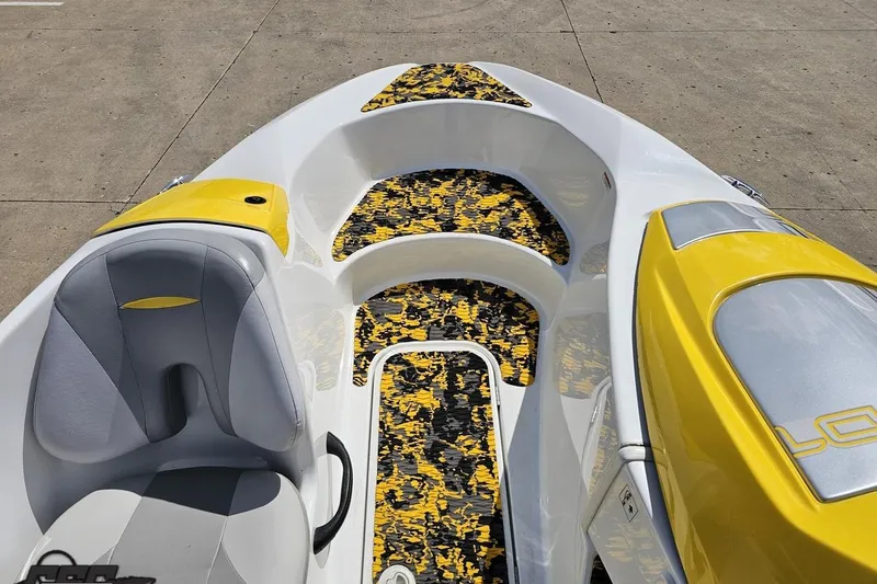Slide: The Image of 2007 Sea-Doo 150 Speedster boat interior with yellow and gray seating, patterned flooring. - 56