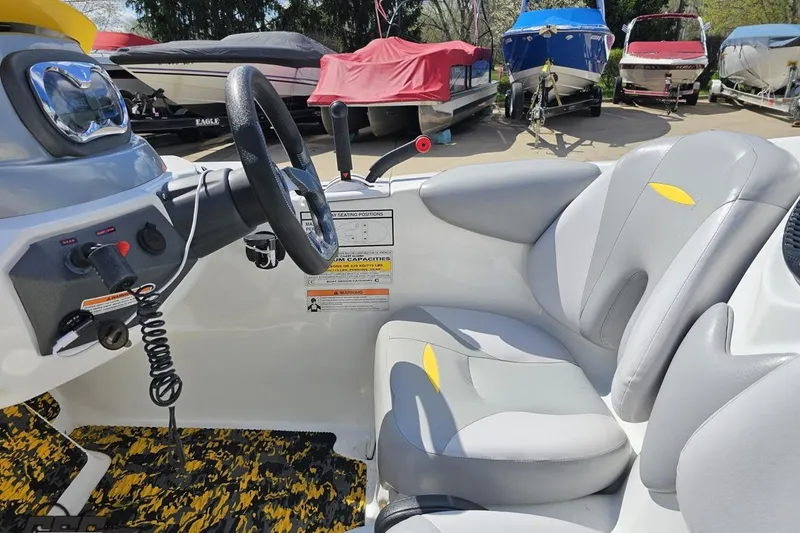 Slide: The Image of 2007 Sea-Doo 150 Speedster cockpit with steering wheel and controls, surrounded by boats. - 57