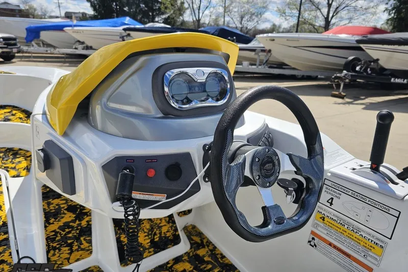 Slide: The Image of 2007 Sea-Doo 150 Speedster dashboard with steering wheel and controls, docked among other boats. - 58
