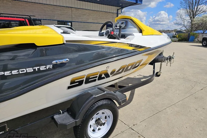 Slide: The Image of 2007 Sea-Doo 150 Speedster boat on trailer, featuring sleek yellow and black design. - 7
