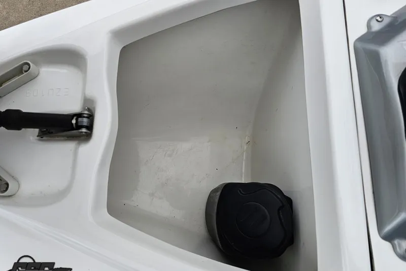 Slide: The Image of Storage compartment of a 2007 Sea-Doo 150 Speedster boat, featuring a black cap. - 72