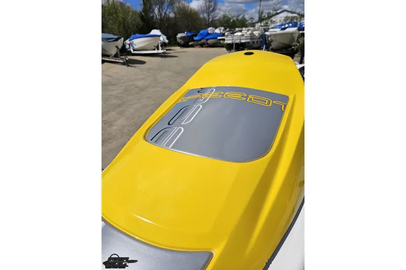 Slide: The Image of 2007 Sea-Doo 150 Speedster with yellow deck, parked among other boats. - 76