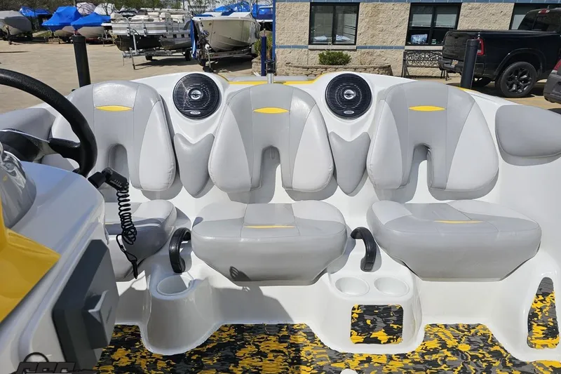 Slide: The Image of 2007 Sea-Doo 150 Speedster interior with gray seats and speakers, parked outdoors. - 78