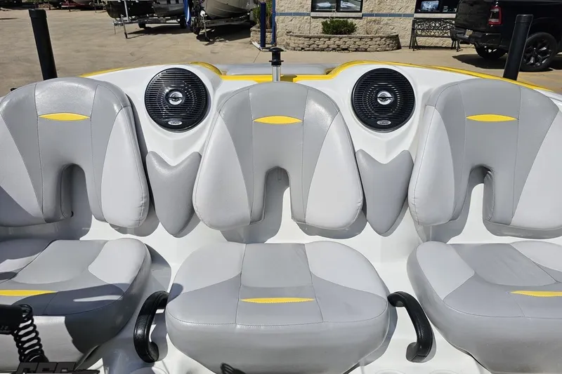 Slide: The Image of 2007 Sea-Doo 150 Speedster interior with gray and yellow seating, featuring built-in speakers. - 79