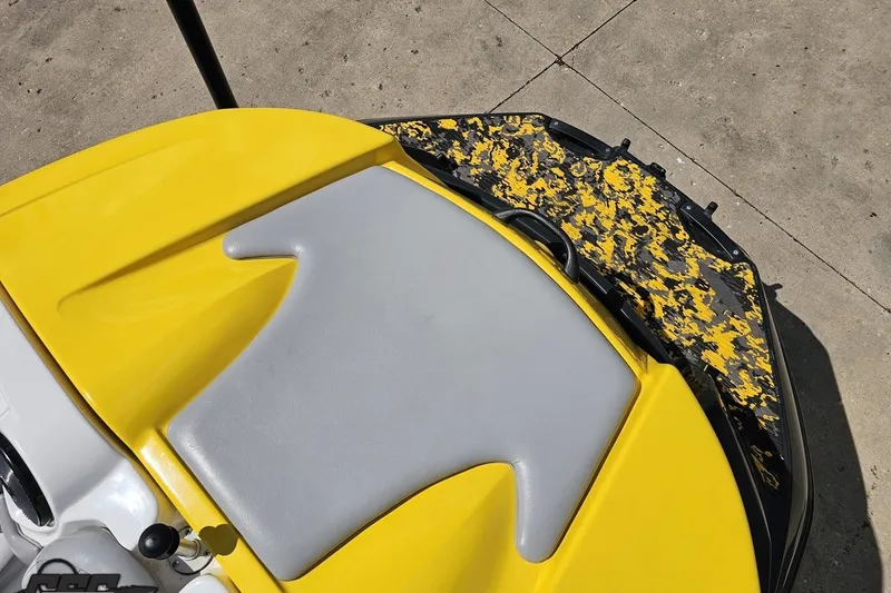 Slide: The Image of 2007 Sea-Doo 150 Speedster boat with yellow and gray seating, camo-patterned deck. - 82