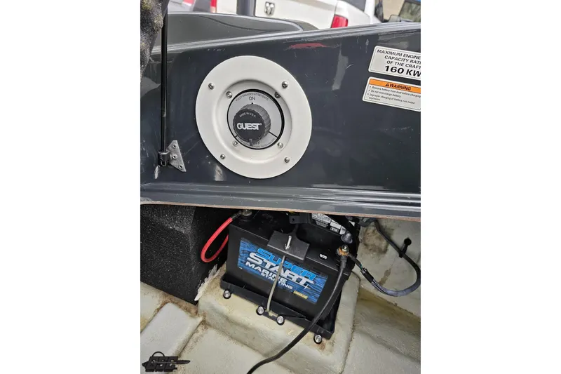Slide: The Image of 2007 Sea-Doo 150 Speedster battery compartment with Guest switch and warning label. - 86