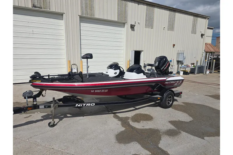 The Image of 2015 Nitro Z-7 boat on trailer, parked outdoors under a clear blue sky. - 0