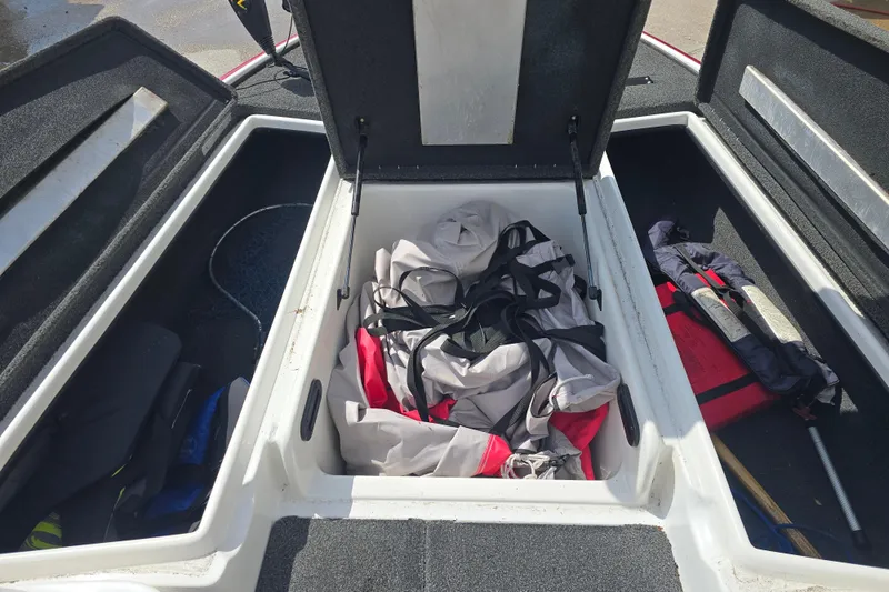 Slide: The Image of Open storage compartments on a 2015 Nitro Z-7 boat, containing life jackets and gear. - 10