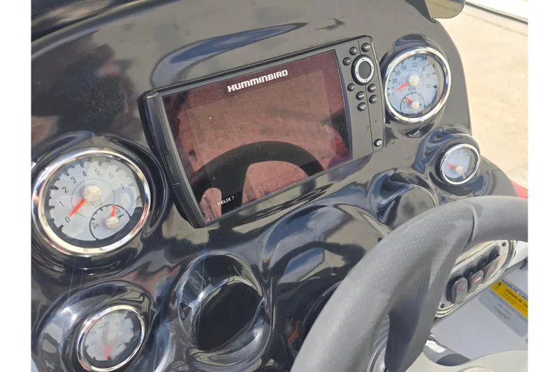 Slide: The Image of Dashboard of a 2015 Nitro Z-7 boat featuring Humminbird Helix 7 display and gauges. - 13