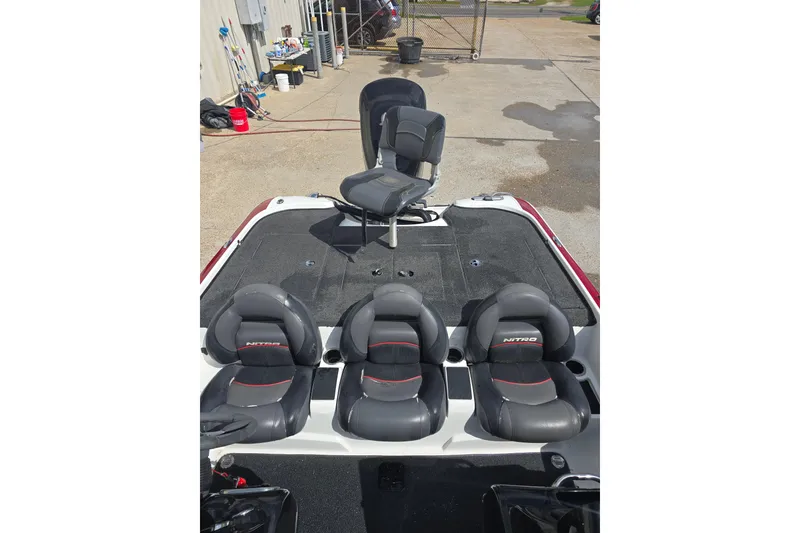 Slide: The Image of 2015 Nitro Z-7 boat with black and gray seating, parked outdoors. - 14