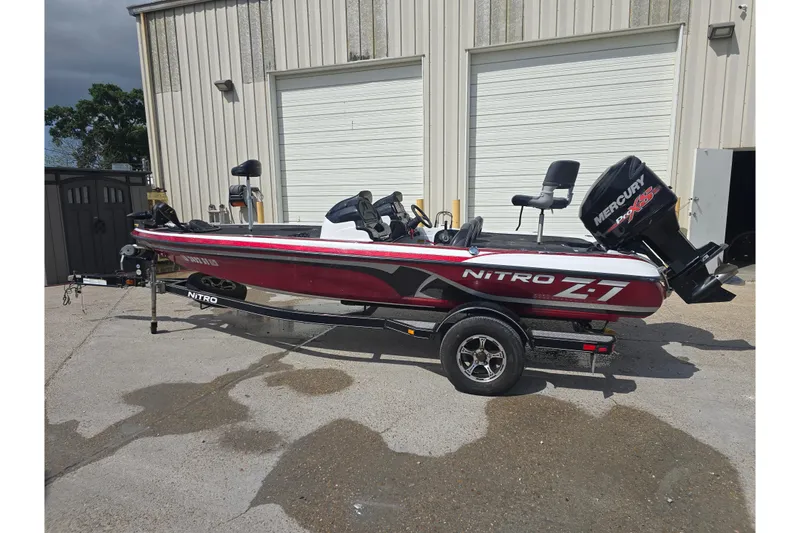 Slide: The Image of 2015 Nitro Z-7 boat with Mercury Pro XS engine on trailer, parked outdoors. - 3