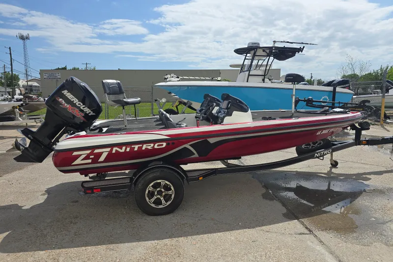 Slide: The Image of 2015 Nitro Z-7 boat with Mercury engine parked outside a garage. - 4