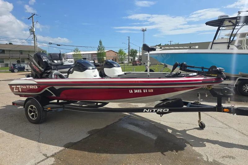 Slide: The Image of 2015 Nitro Z-7 boat with Mercury engine on trailer, parked outdoors. - 5
