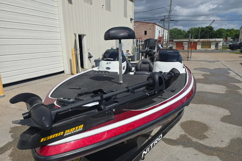 Slide: The Image of 2015 Nitro Z-7 boat with Minn Kota trolling motor, parked outdoors. - 6