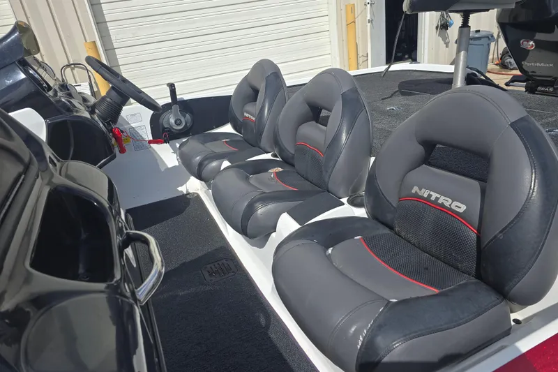 Slide: The Image of 2015 Nitro Z-7 boat interior with gray and red cushioned seats. - 9