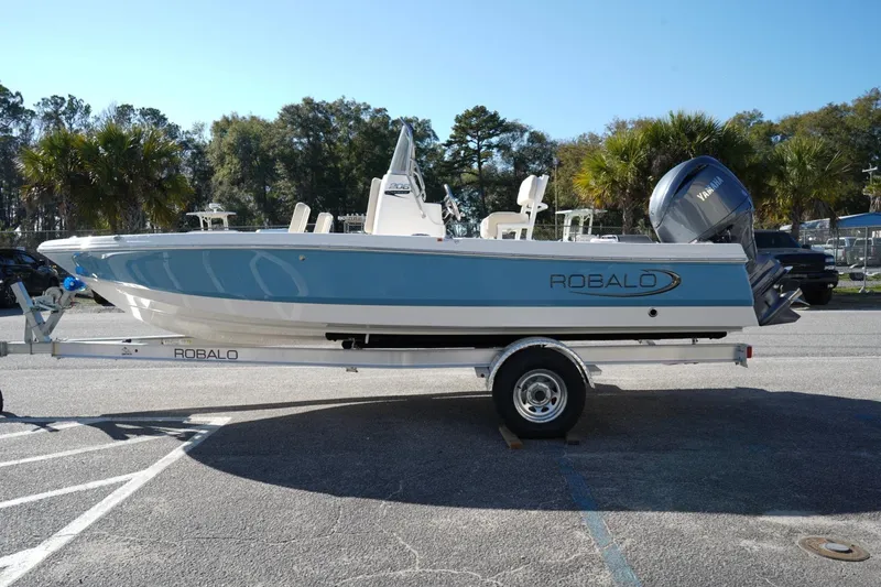 The Image of 2026 Robalo 206 Cayman boat on trailer, parked outdoors, side view. - 0