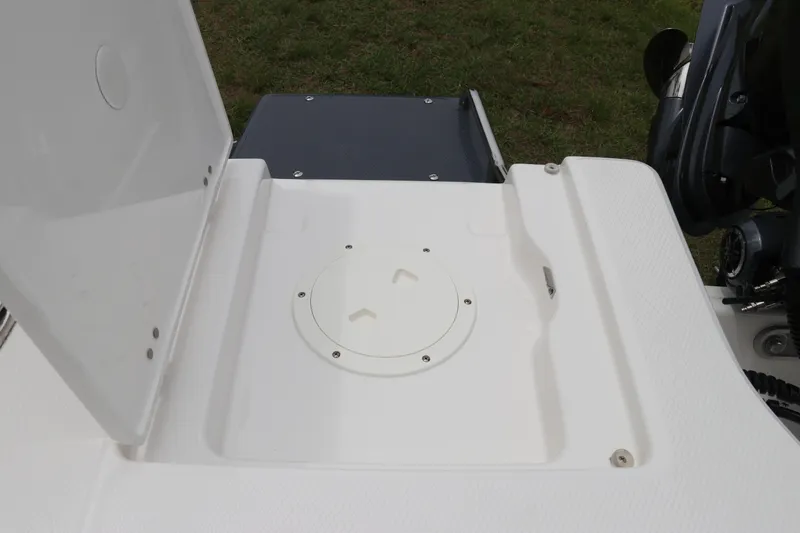 Slide: The Image of 2026 Robalo 206 Cayman boat deck with open hatch, showcasing storage compartment. - 10