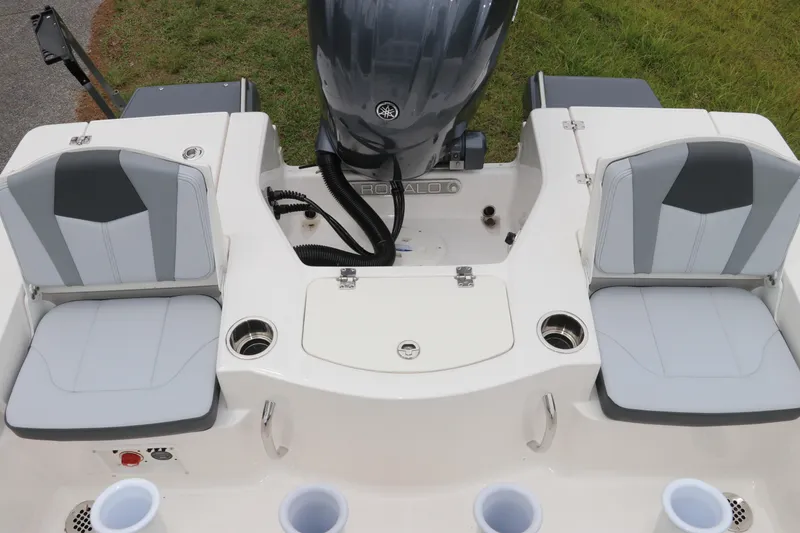 Slide: The Image of 2026 Robalo 206 Cayman boat interior with dual seating and motor, showcasing modern design. - 12