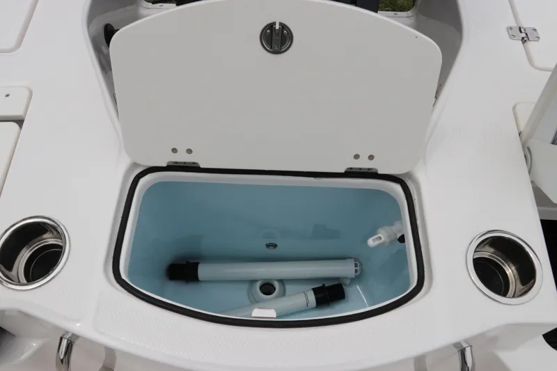 Slide: The Image of Open storage compartment on 2026 Robalo 206 Cayman boat with cup holders. - 14