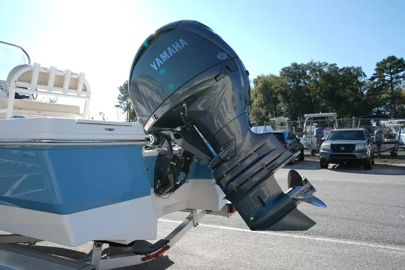 Slide: The Image of 2026 Robalo 206 Cayman boat with Yamaha outboard motor, parked on a trailer. - 2