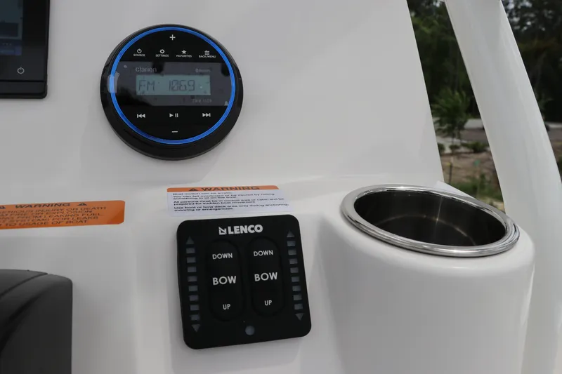 Slide: The Image of Control panel of 2026 Robalo 206 Cayman boat with radio and trim tab switches. - 22