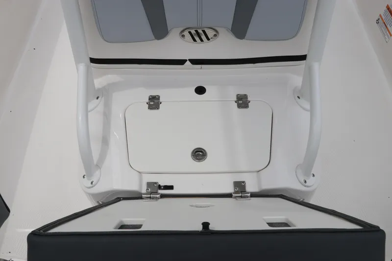 Slide: The Image of 2026 Robalo 206 Cayman boat storage compartment with open hatch and seating. - 24