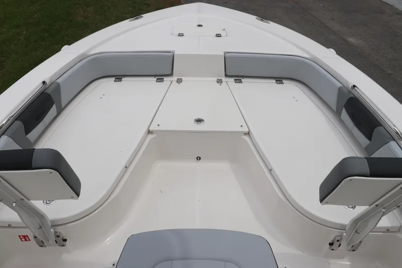 Slide: The Image of 2026 Robalo 206 Cayman boat interior with cushioned seating and storage compartments. - 27