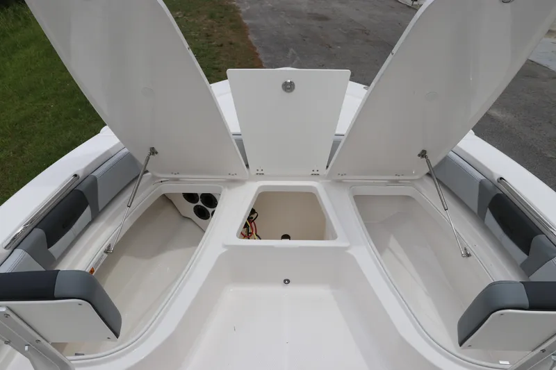 Slide: The Image of 2026 Robalo 206 Cayman boat storage compartments open, showcasing spacious interior design. - 28