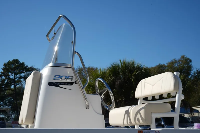 Slide: The Image of 2026 Robalo 206 Cayman boat console and seating under clear blue sky. - 3