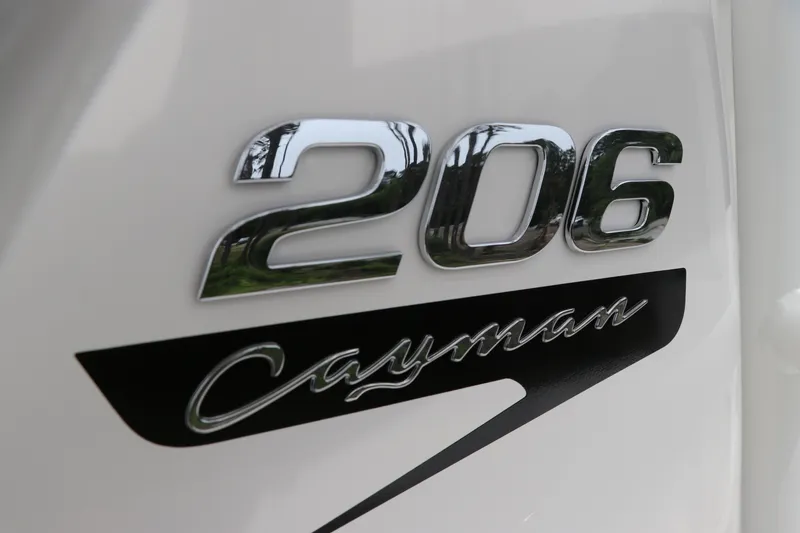 Slide: The Image of Chrome emblem of 2026 Robalo 206 Cayman boat on white surface. - 32