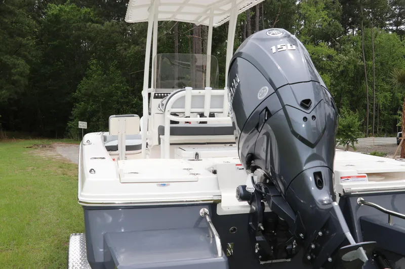 Slide: The Image of 2026 Robalo 206 Cayman boat with Yamaha 150 engine, parked on grass. - 5