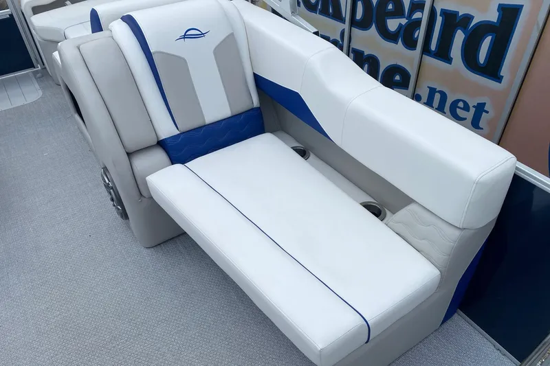 Slide: The Image of 2026 SunCatcher Elite 326 SS boat interior with white and blue seating. - 10