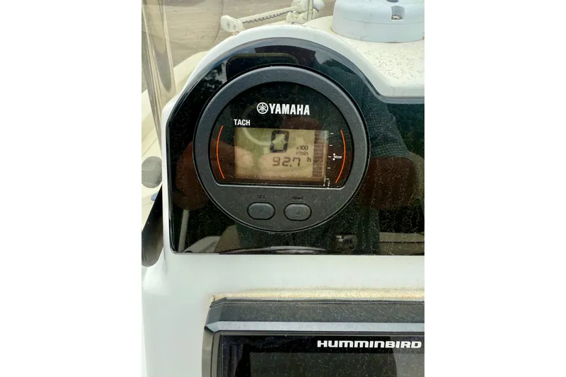 Slide: The Image of Yamaha tachometer on 2017 NauticStar 227 XTS boat dashboard, displaying 92.7 hours. - 10