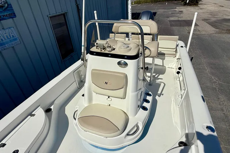 Slide: The Image of 2017 NauticStar 227 XTS boat interior with beige seating and control console. - 6